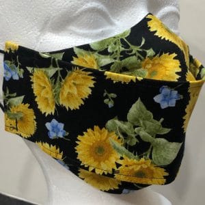 Large yellow and tiny blue flowers on black mask