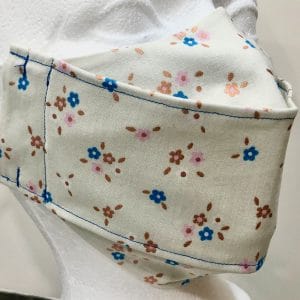 Blue pink and shiny gold pastel mini flowers on cream base mask